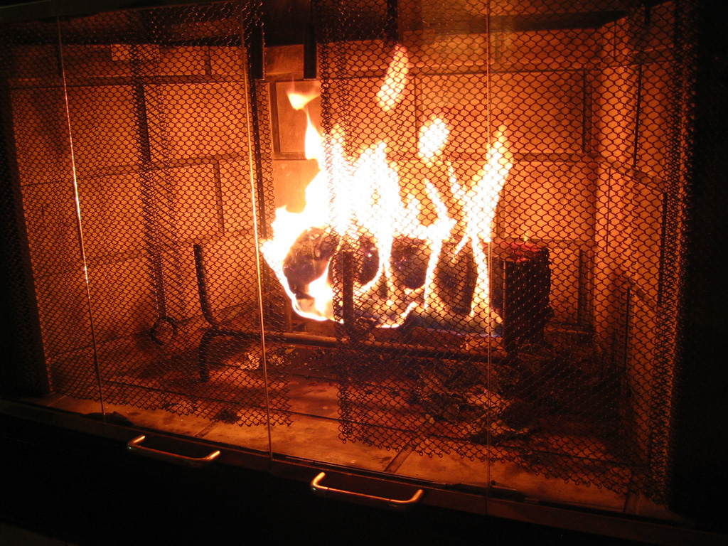 a lit log in a fireplace