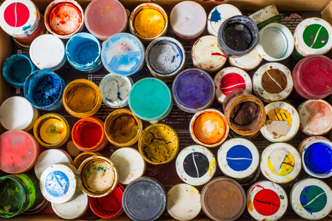 assorted used and open paint cans