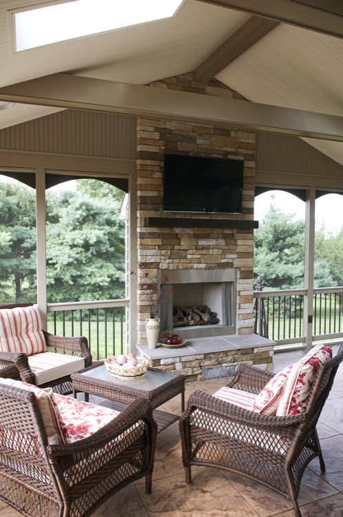 stone fireplace and backyard seating area