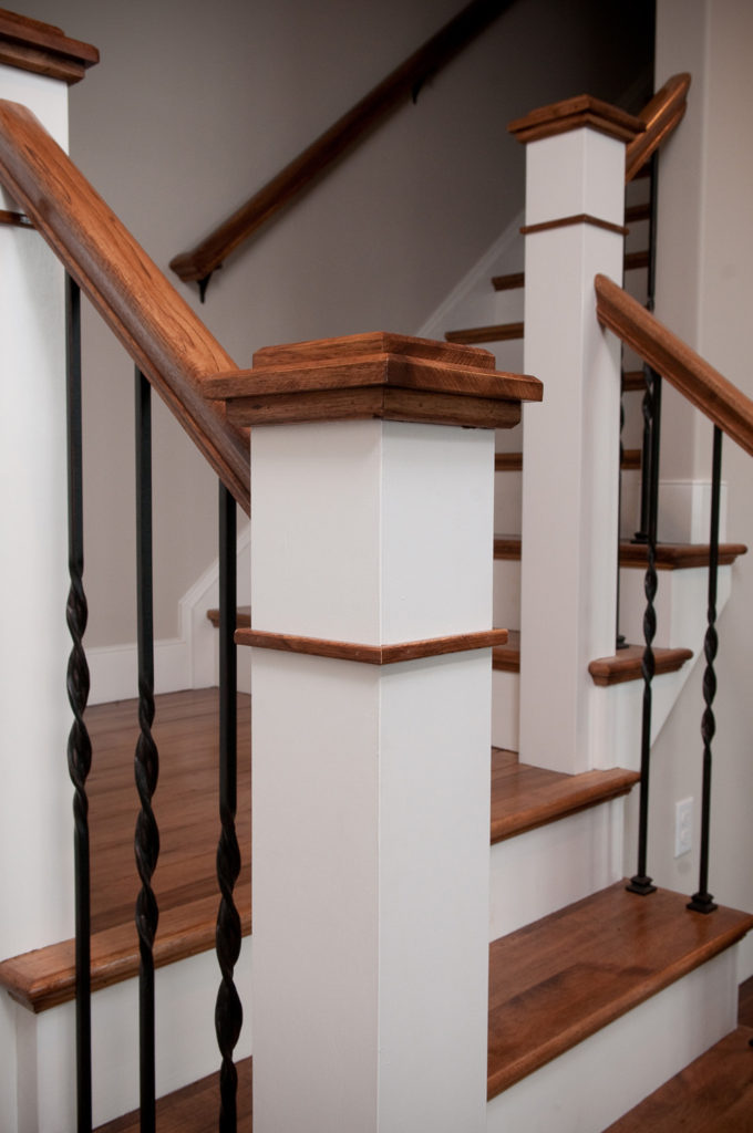Custom Newel Post with Iron Pickets on a staircase