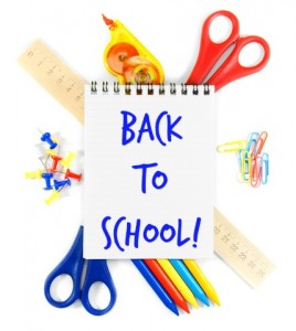 back to school on a notepad laying on various school supplies