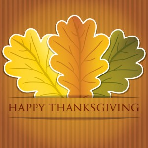 happy thanksgiving graphic with three fall leaves