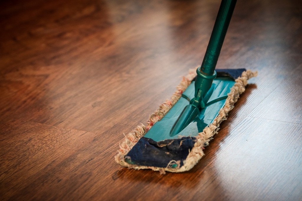 old mop duster cleaning a hardwood floor