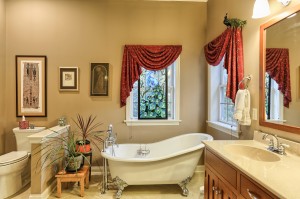 master bathroom with soak tub and his/her vanities