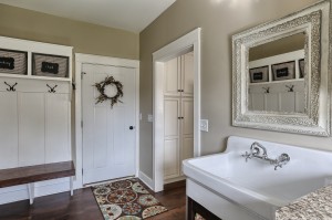 laundry room with built in storage, sink and hangers