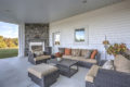 covered outdoor patio area with furniture and fireplace