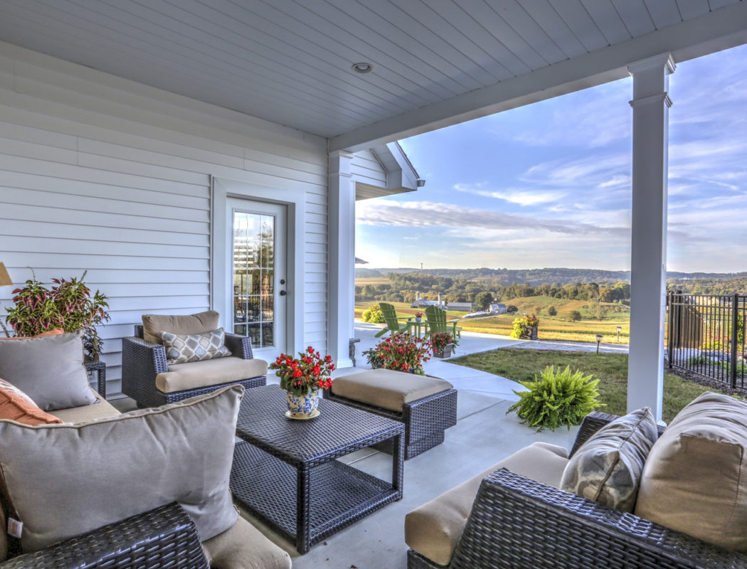 covered outdoor patio area with furniture and fireplace