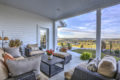 covered outdoor patio area with furniture and fireplace