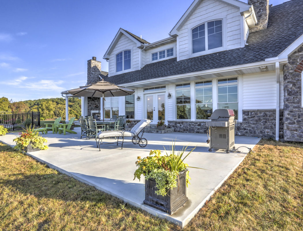 backyard porch area with grill, flower boxes and furniture