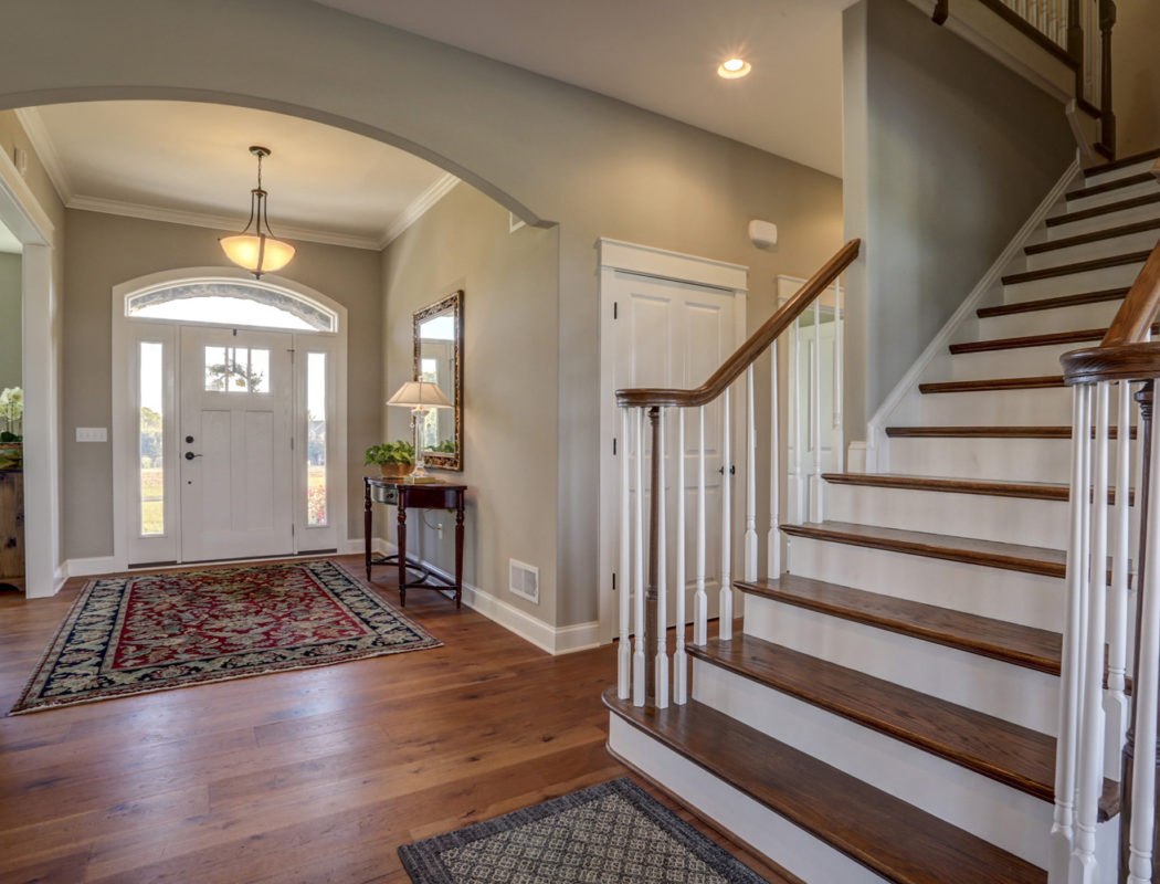 entryway with wood floors and staircase