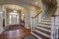 entryway with wood floors and staircase