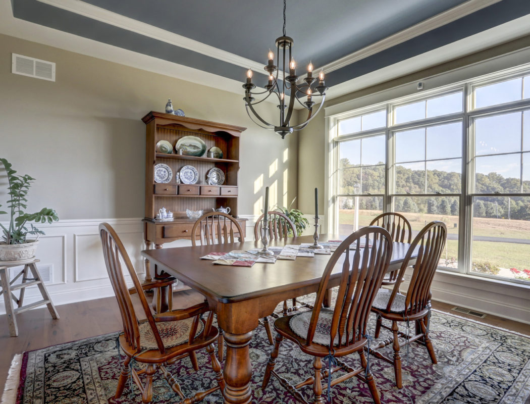 dining room table with cabinet and large windows