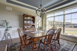 dining room table with cabinet and large windows