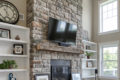 stone fireplace with mounted TV overhead
