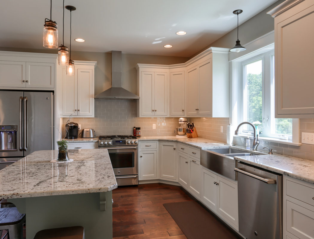 kitchen with island, white cabinets and stainless steel appliances