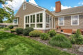 various green plants in a flowerbed behind a home