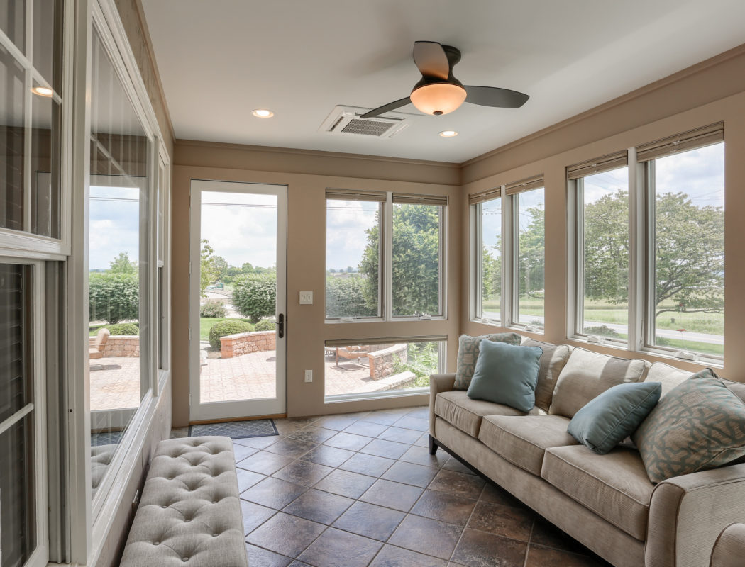 covered backdoor patio area with fan