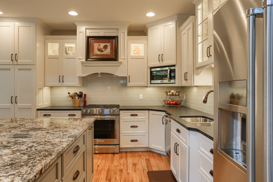 kitchen with white cabinets, large stone countertops and stainless steel appliances