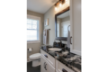 toilet and sink with stone countertop