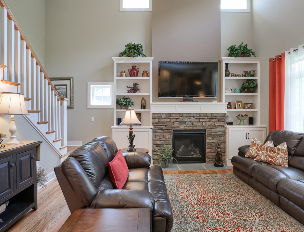 living room with stone fireplace