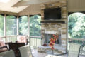 stone fireplace with a tv mounted above it