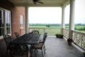 patio furniture on a deck overlooking farmland