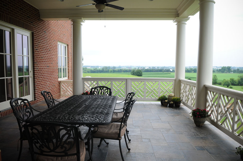 patio furniture on a deck overlooking farmland