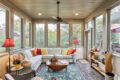 a sunroom with a wraparound couch