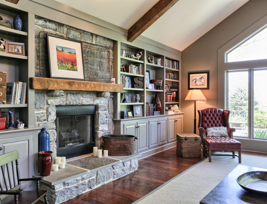 family room with stone fireplace and built in shelves