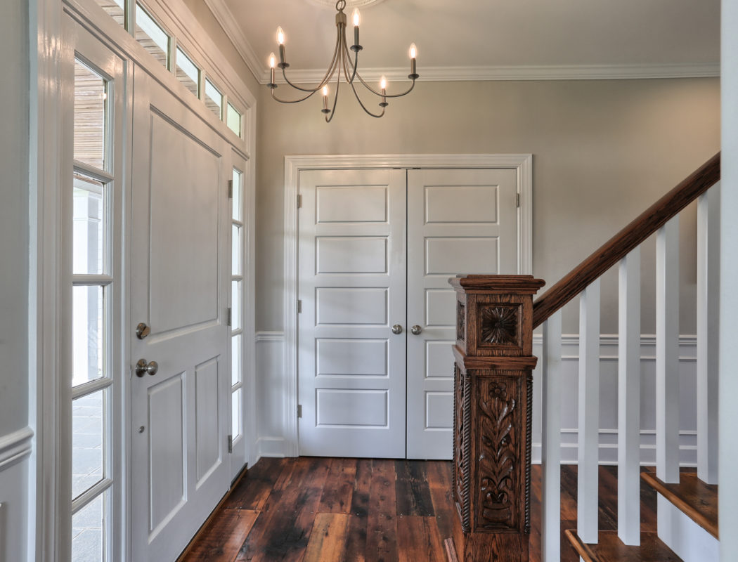 custom home entryway and wood railing for staircase