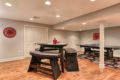 seating area with a pingpong table in the back of a recent Metzler Home Builders basement renovation