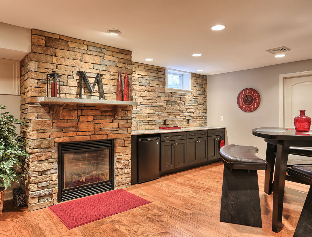 fireplace and stonewall in a finished basement