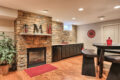 fireplace and stonewall in a finished basement