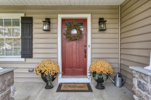 front porch with red door - built by custom home builder metzler home builders