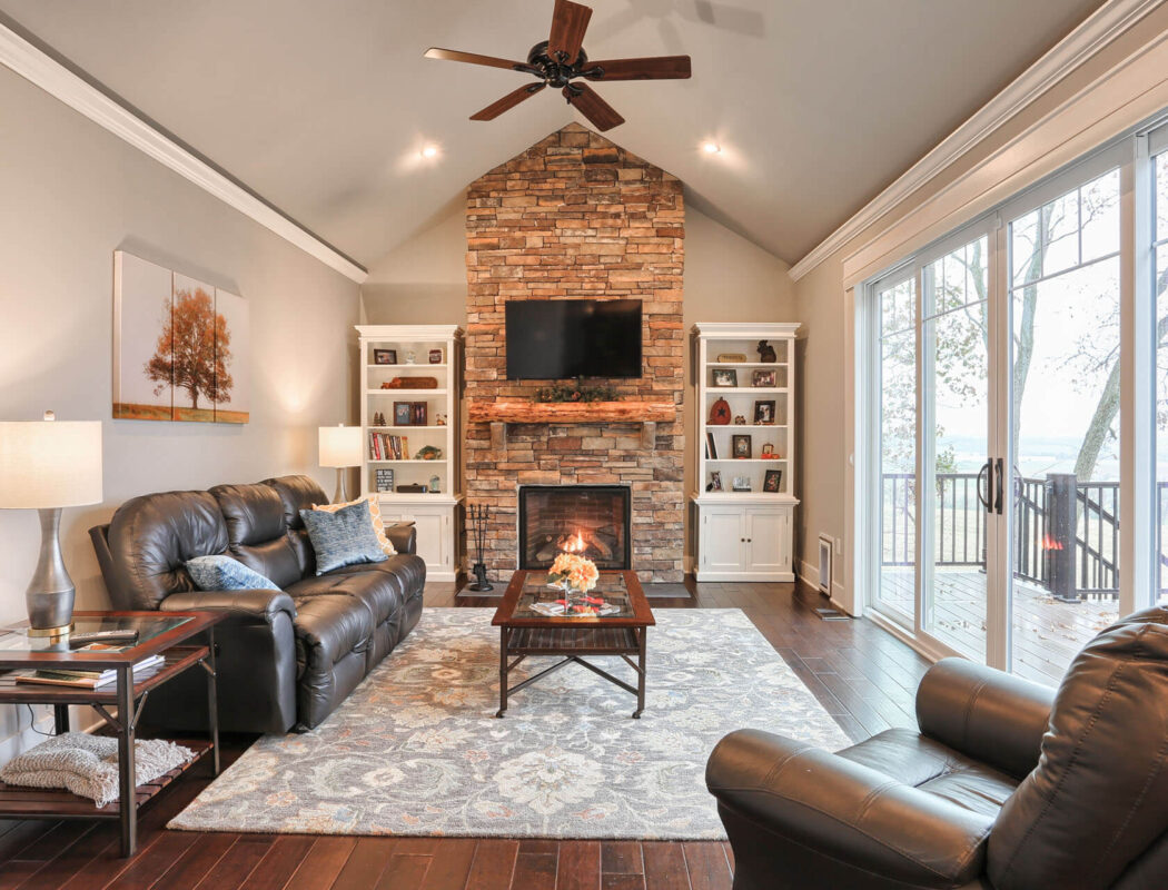 living room with stone fireplace