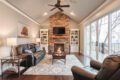 living room with stone fireplace
