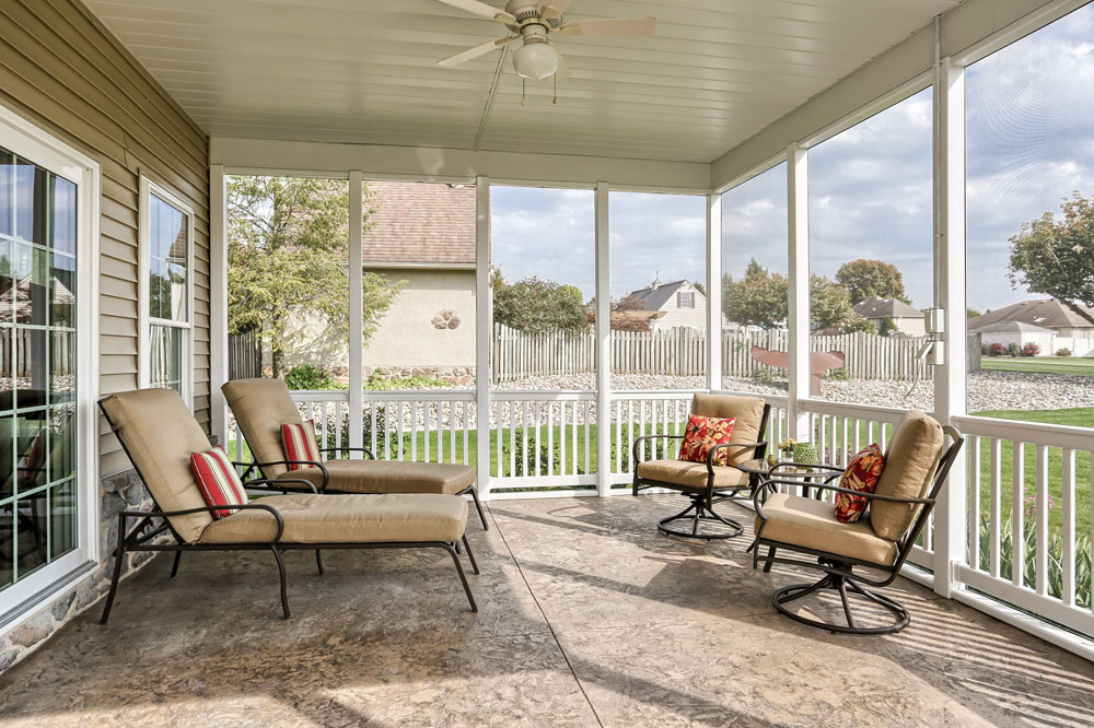 screened in porch with outdoor furniture