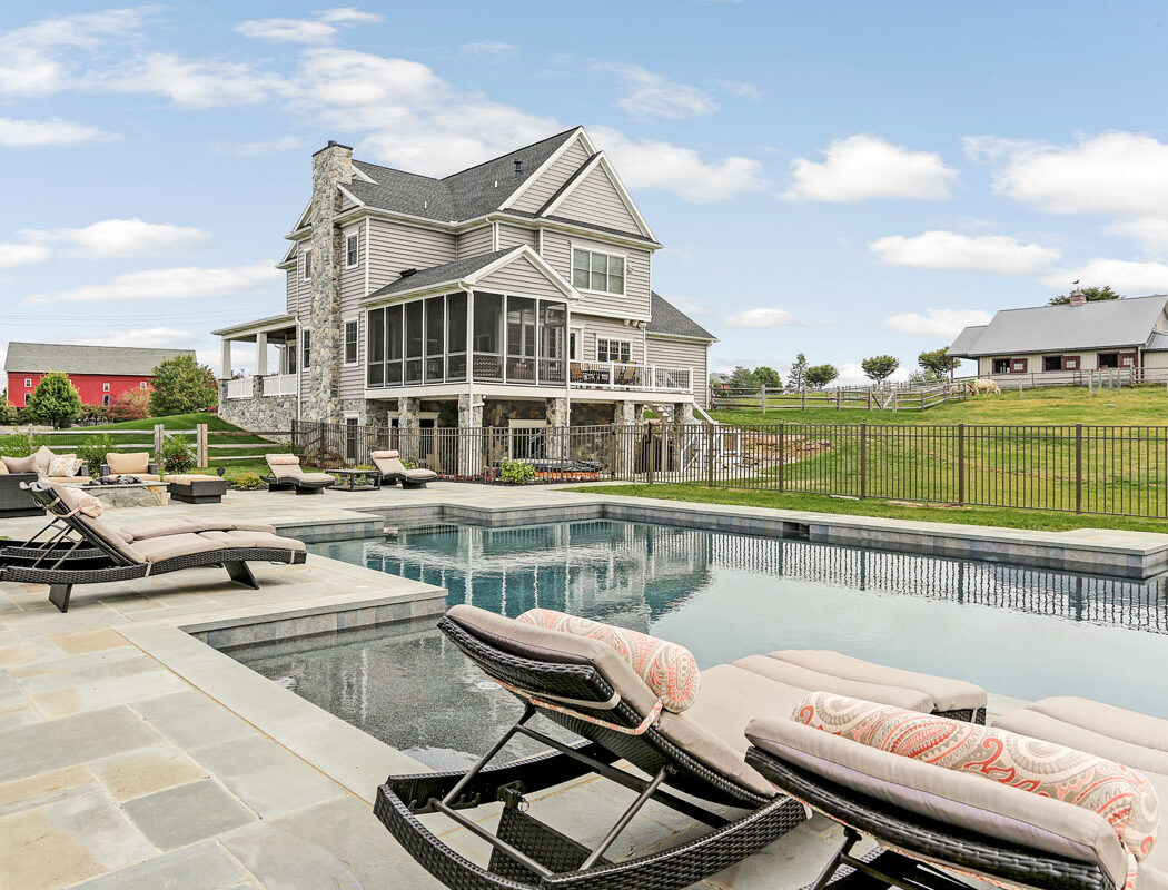 poolside looking at the back of a home built by Metzler Home Builders