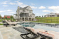 poolside looking at the back of a home built by Metzler Home Builders