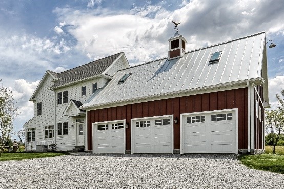 3 car garage with white doors attached to a hoem