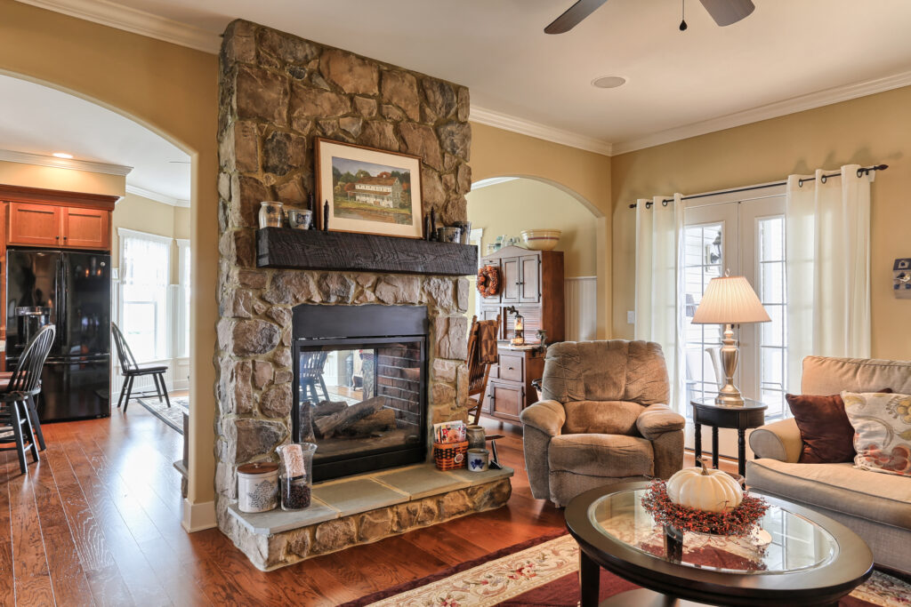 stone-surround-two-sided-fireplace-wood-mantel